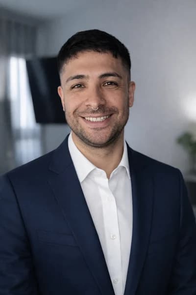 Portrait of Marcos, in a suit, at the office
